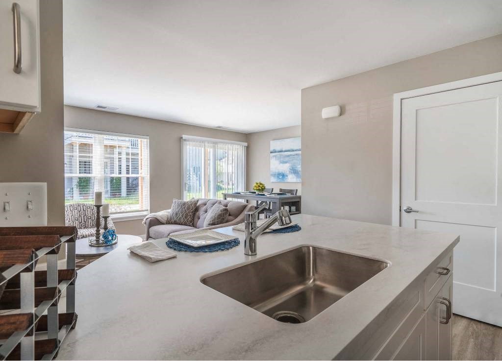 View from kitchen towards great room with living and dining areas
