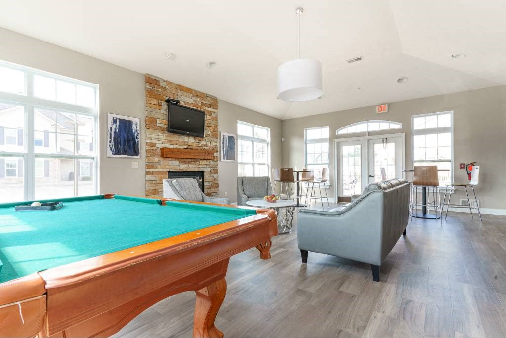 Lehigh Park Community Center with pool table, fireplace, flat screen tv, seating area, and high-top tables