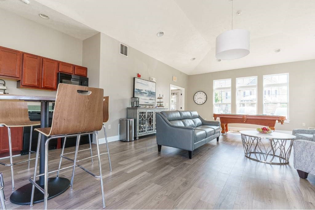 View of Community Center showing kitchenette, high top table, seating area, and pool table