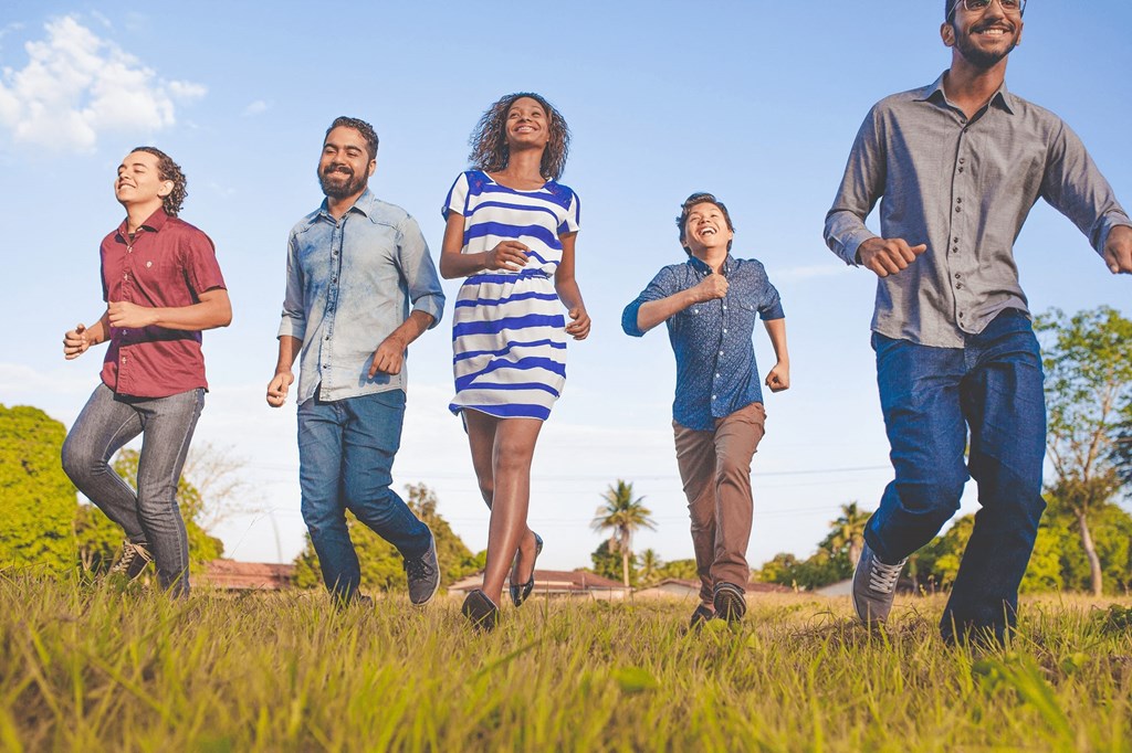 a group of people running together in a field