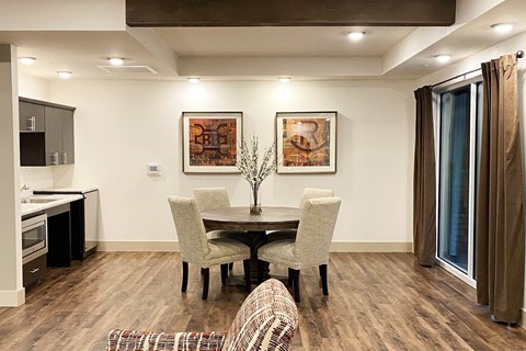 a dining room with a table and chairs and a kitchen