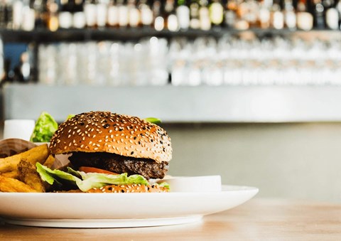 a plate with a hamburger and fries on a table