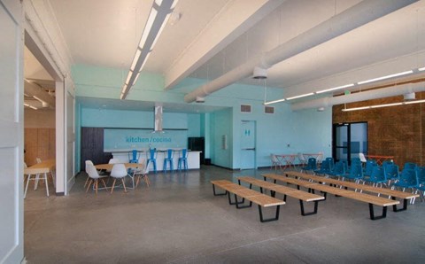 a large room with benches and chairs and tables