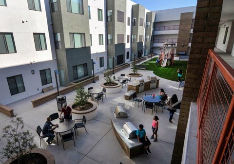 people in an outdoor courtyard of an apartment building