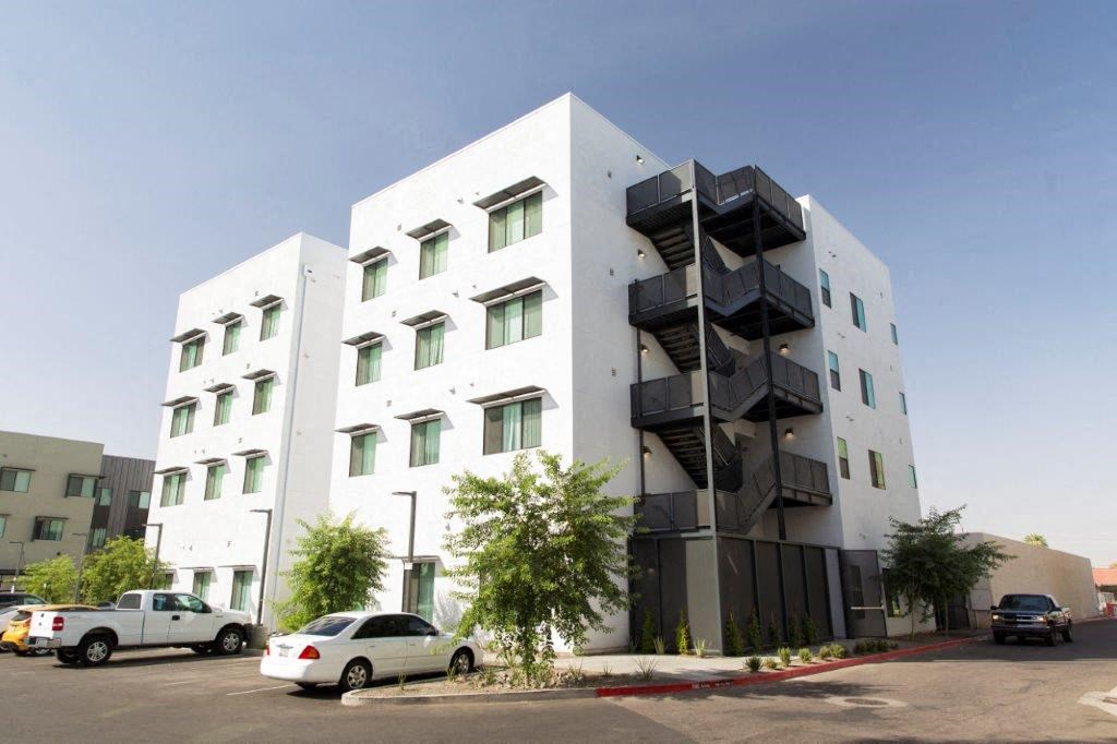 a white building with cars parked in front of it