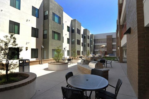 a patio with tables and chairs in the middle of a building