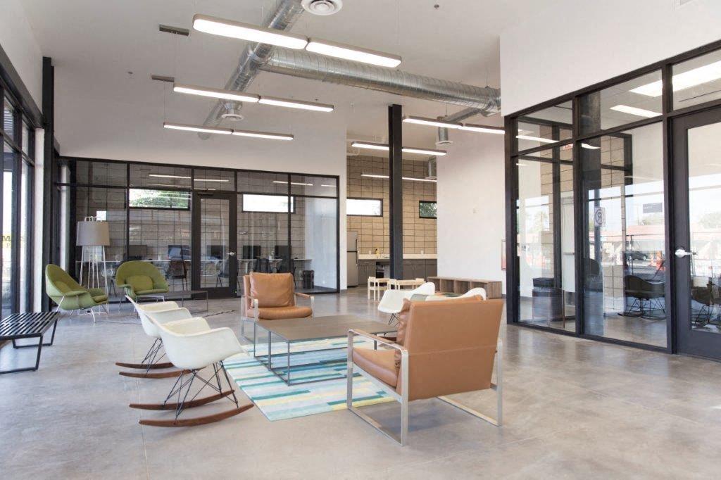 a large lobby with chairs and a table