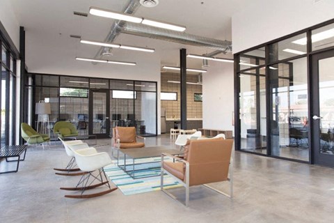 a large lobby with chairs and a table