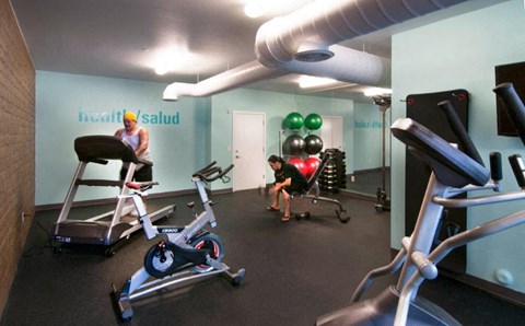 a group of people in a gym with exercise equipment