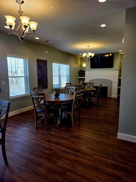 A dining room with a table and chairs.