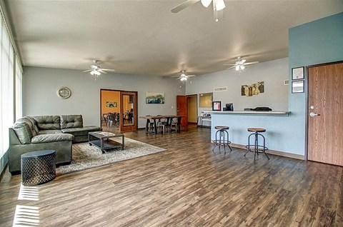 the living room and kitchen of a house with a wood floor
