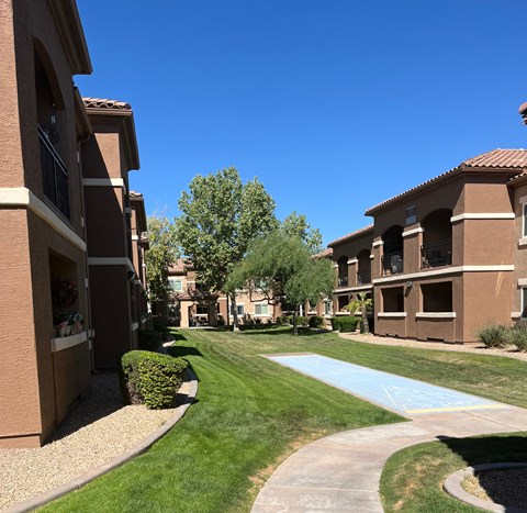 A sunny day at a residential complex with a clear blue sky.