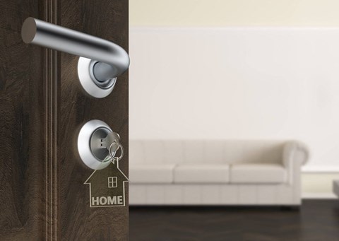 A modern door handle with a keyhole and a key.