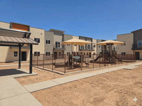 A row of houses with a playground in the foreground.