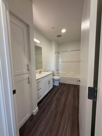 A white bathroom with a toilet and sink.