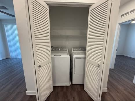 A white cabinet with two washing machines inside.