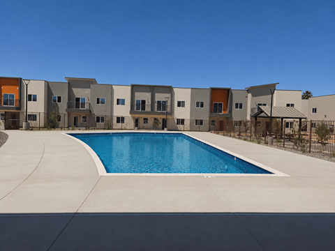 A swimming pool in front of a row of houses.