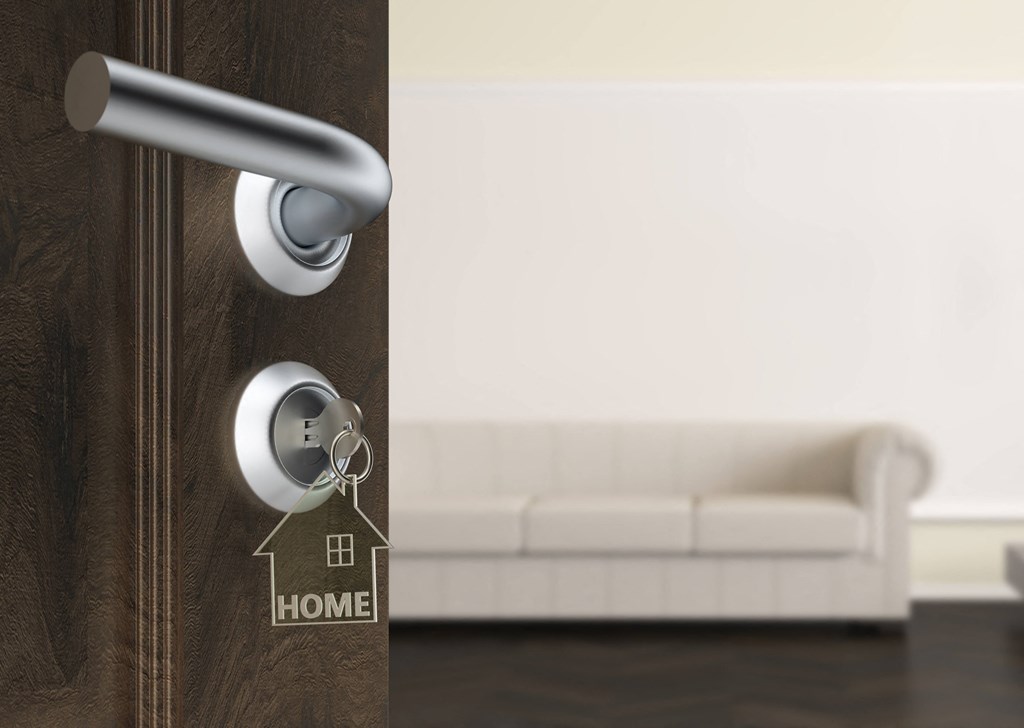 a door with a house key on the door handle