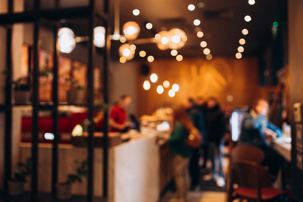 people in a restaurant with lights in the background