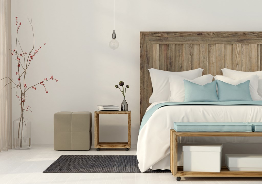 a bedroom with a bed and a wooden headboard