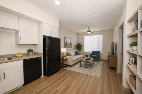 A modern kitchen with black appliances and white cabinets.