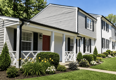 A house with a grey siding and white trim.