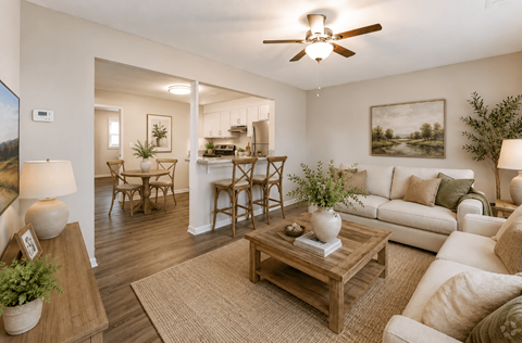 A living room with a white couch, a wooden coffee table, and a ceiling fan.