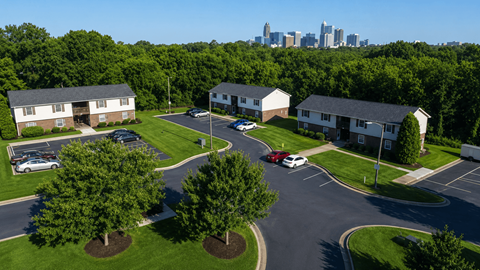 A view of a housing complex with a city skyline in the background.