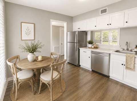 A kitchen with a table and chairs in the middle of the room.