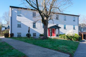a white house with a tree in front of it at Viceroy Apartments, Durham , 27707
