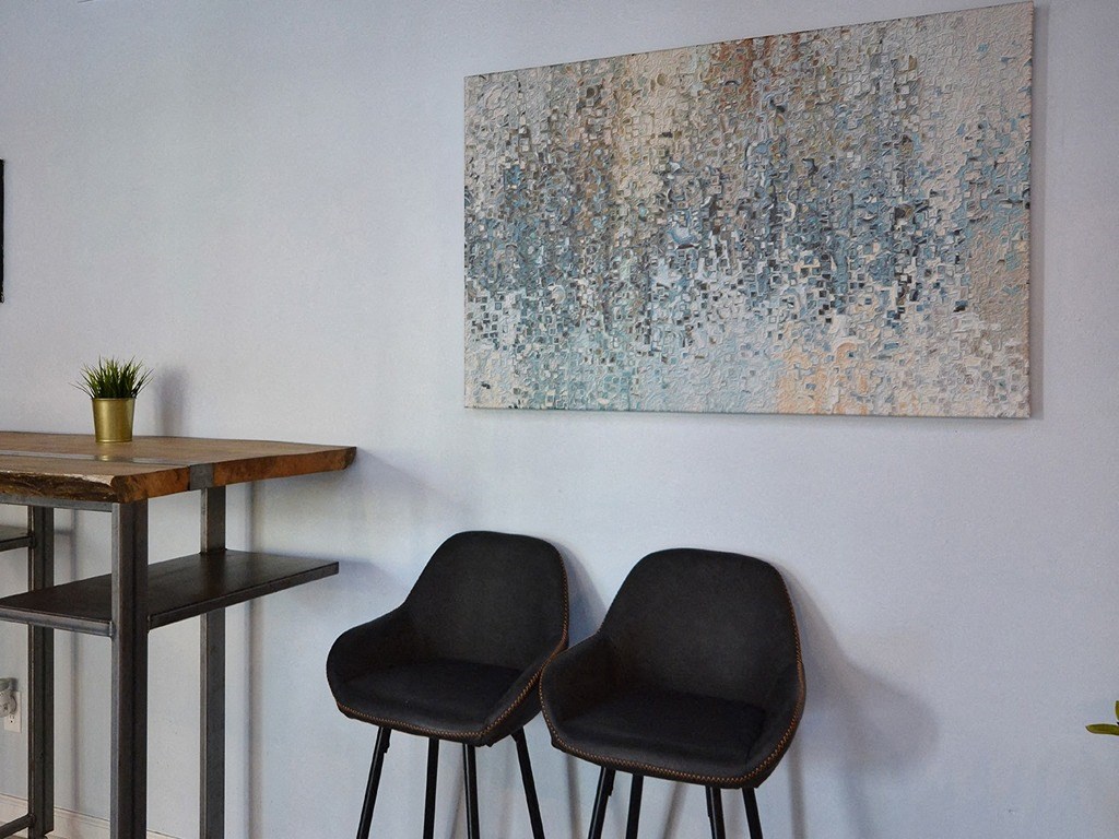 two chairs in a room with a painting on the wall