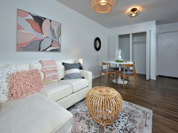 a living room and dining room with a couch and a table at Capital Flats & Magnolia Square Apartments, Raleigh, NC, 27601