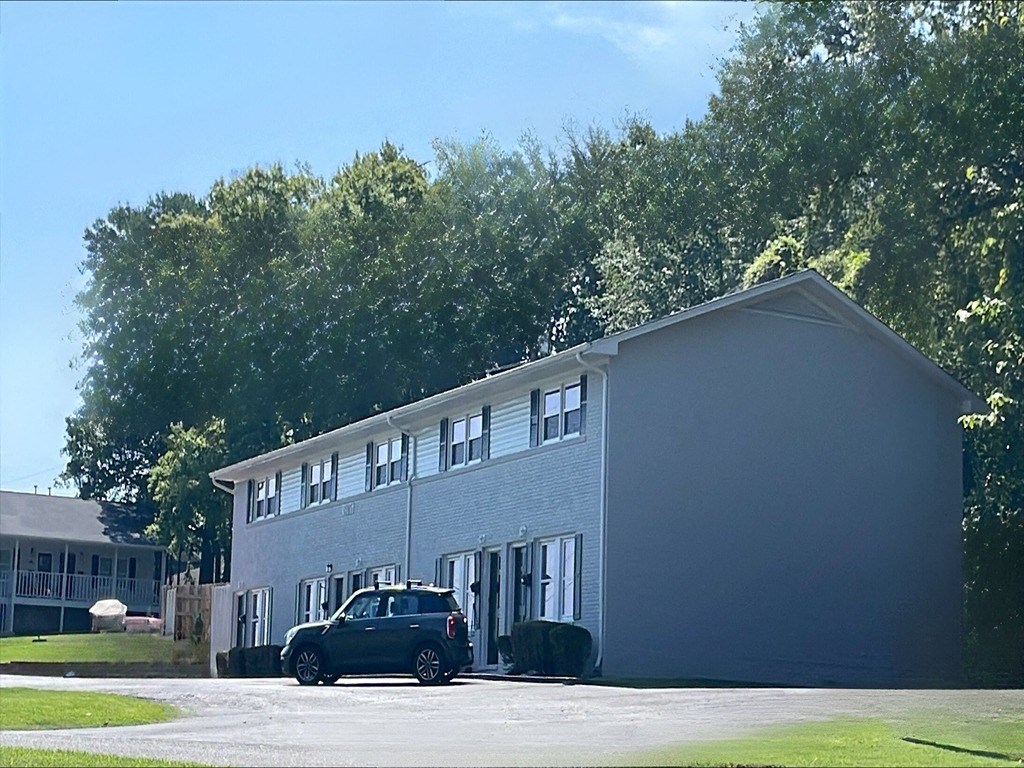a blue building with a car parked in front of it