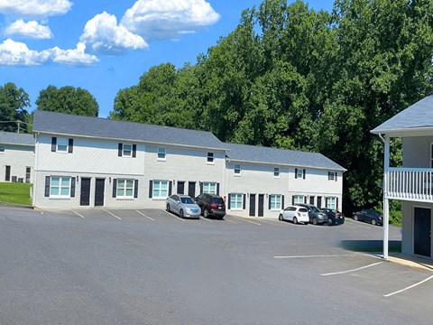 an apartment building with cars parked in front of it