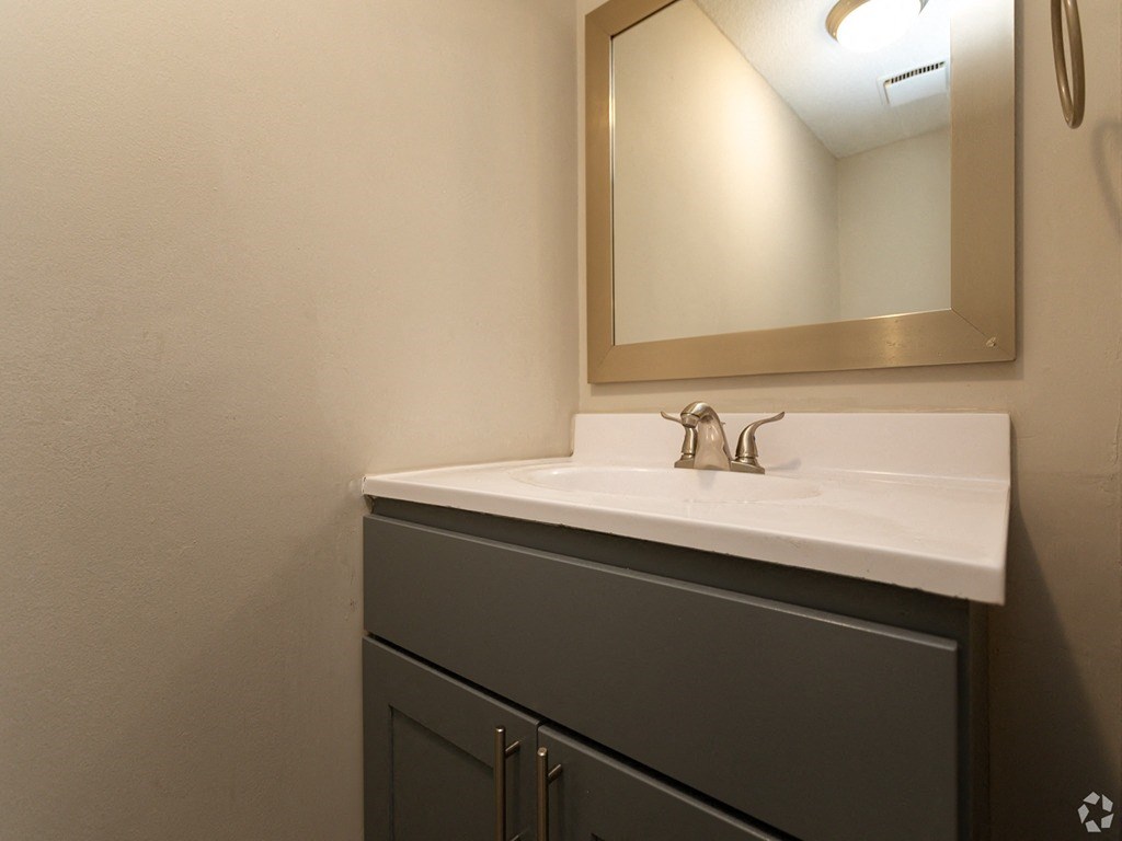 an empty bathroom with a sink and a mirror
