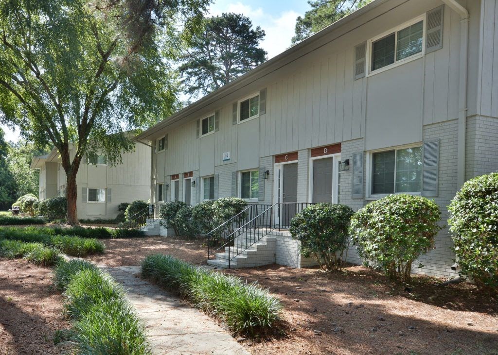 the exterior of a building with stairs and a sidewalk