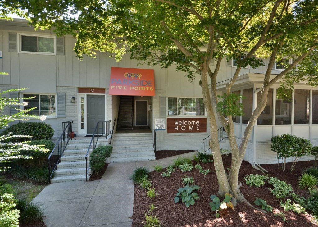 the front of a building with steps and a sidewalk