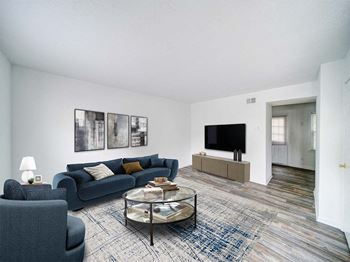 a living room with a blue couch and a tv