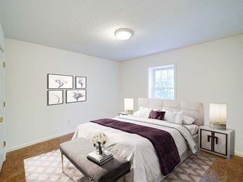 an empty bedroom with a bed and a window