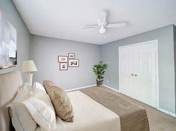 a bedroom with a large bed and a ceiling fan