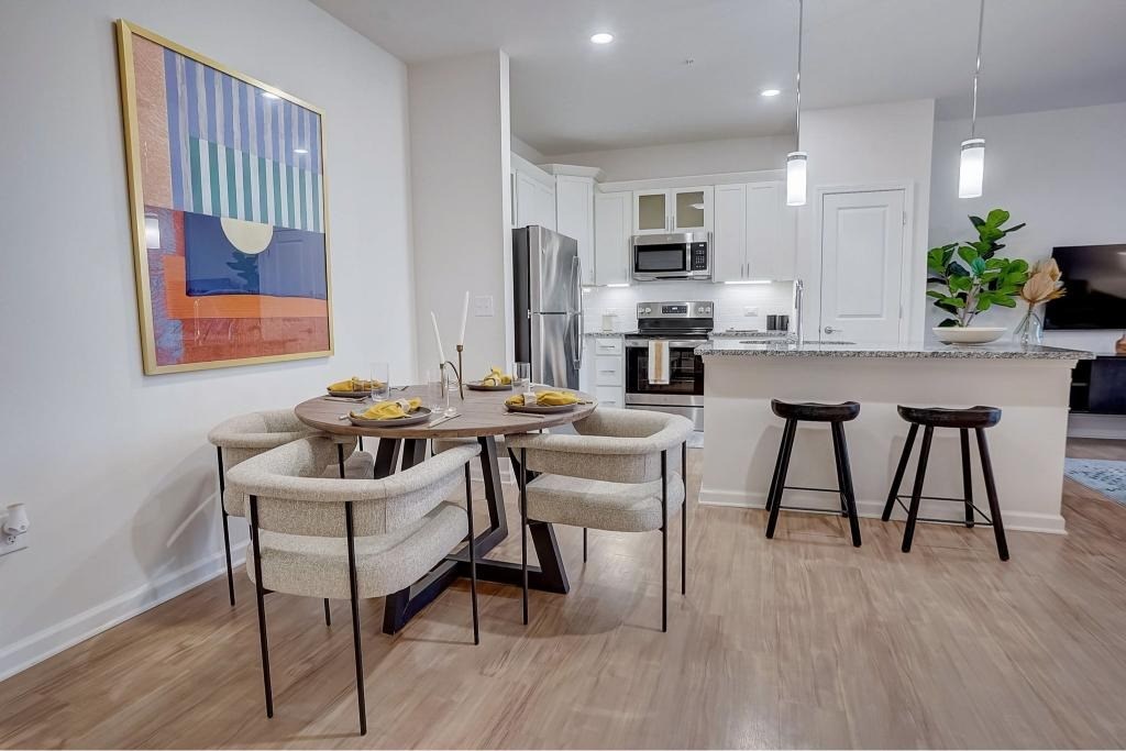 A kitchen with a dining table and chairs.at Evolve at Parkway Apartment Homes, Concord, 28027