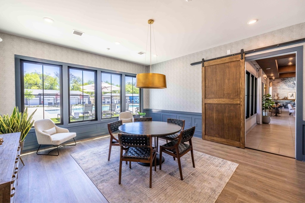 A dining room with a round table and chairs.at Evolve at Parkway Apartment Homes, Concord North Carolina