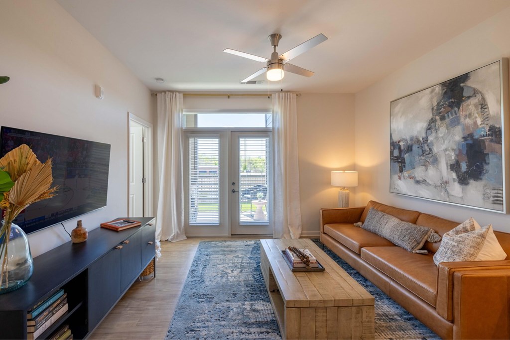 Living Room With Ceiling Fan at Evolve at Parkway Apartment Homes, North Carolina, 28027