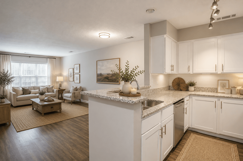 A kitchen with white cabinets and a marble countertop.