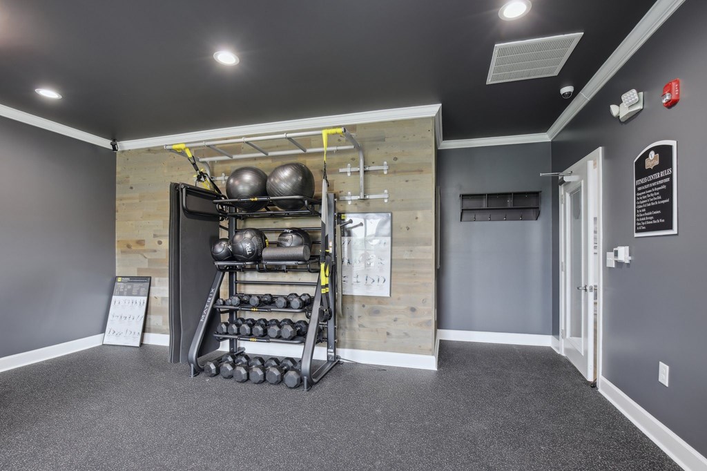 A gym room with a rack of weights and a sign that say at Venue at 109 Apartments, Lebanon , Tennessee