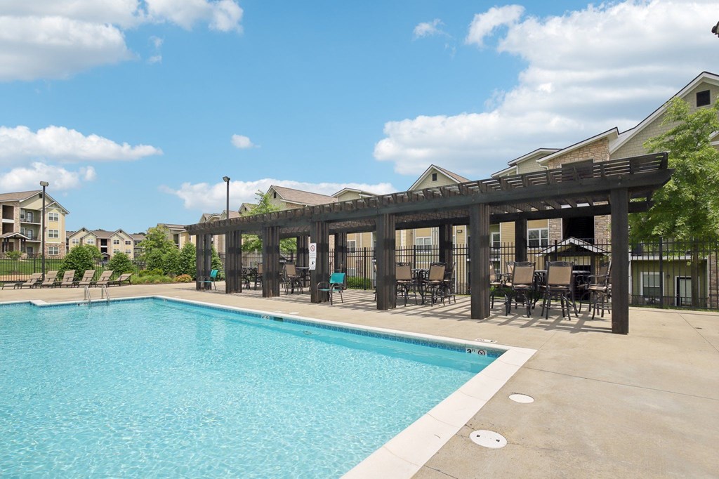 A large swimming pool with a wooden pergola over it at Venue at 109 Apartments, Tennessee, 37090