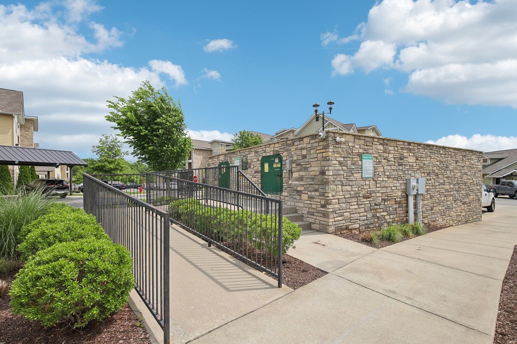 A stone building with a green sign on it at Venue at 109 Apartments, Lebanon , TN, 37090