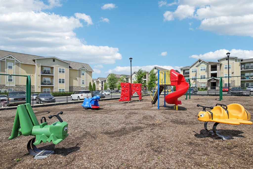 A playground with a green toy tractor and a yellow toy car at Venue at 109 Apartments, Lebanon  37090