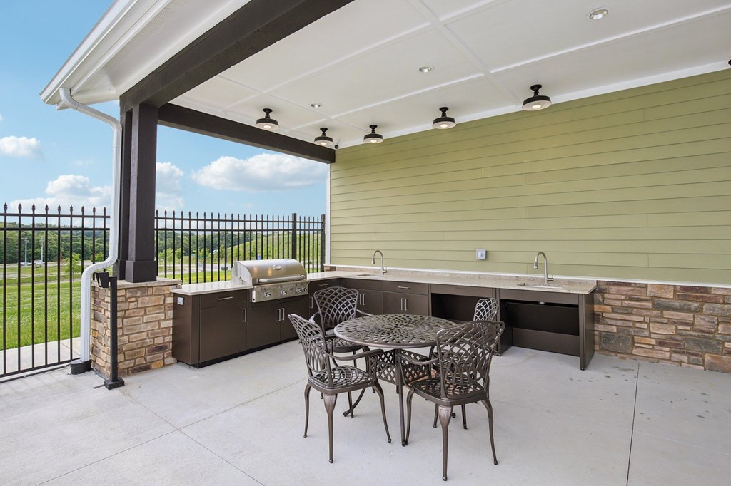 A patio with a table and chairs is covered by a roof at Venue at 109 Apartments, Lebanon 