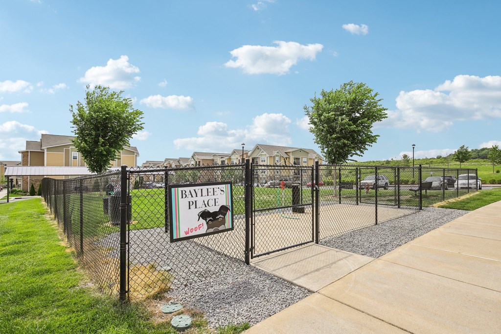 A sign for Bamblee's Place sits on a fence in front of a building at Venue at 109 Apartments, Lebanon , TN, 37090